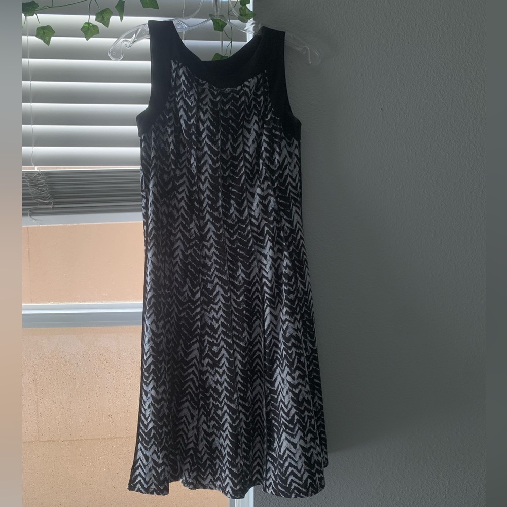 A mini black dress with white stripes. It’s a small.
